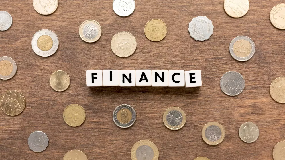 Fichas que forman la palabra "Finance" con monedas de varios países.